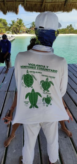 Isla Contoy park rangers wearing a sea turtle protection campaign t-shirt.